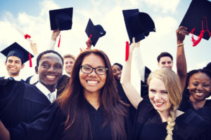 Sports Psychology students on graduation day in caps and gowns.