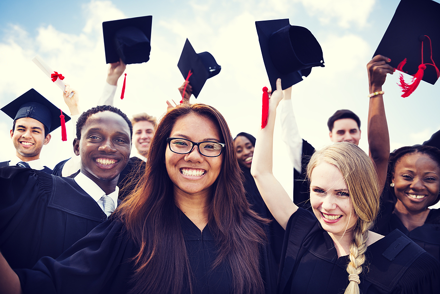 Sports Psychology students on graduation day in caps and gowns.